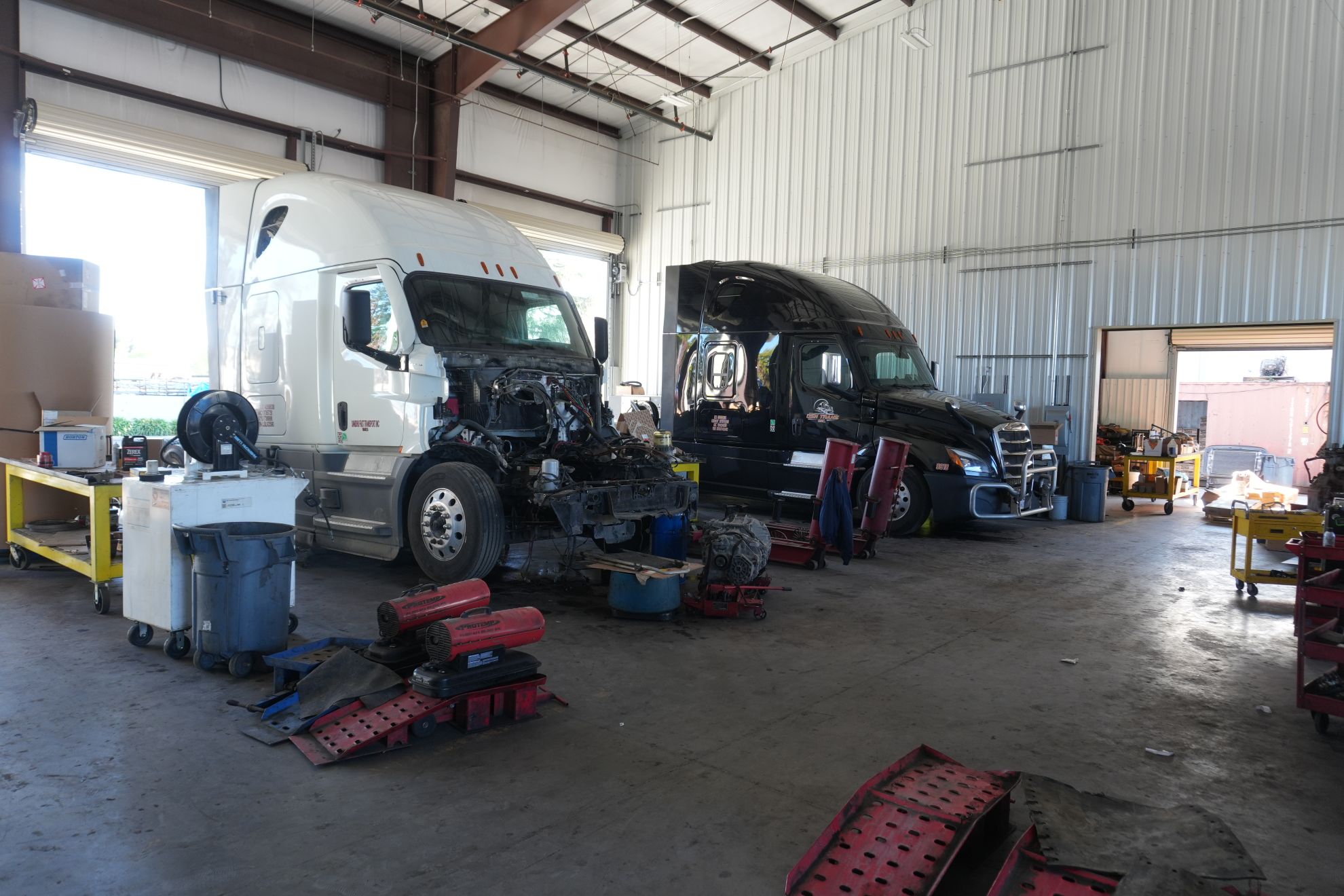 Inside the Fleet Nation 8-bay shop with service trucks and lifts